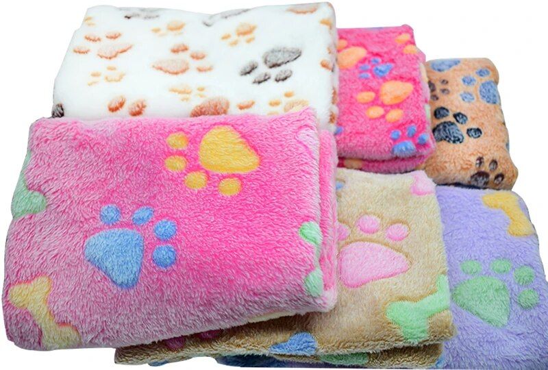 Stack of colorful, folded fleece blankets with various paw print patterns, perfect for cozy moments (11395-2a484b.jpg).